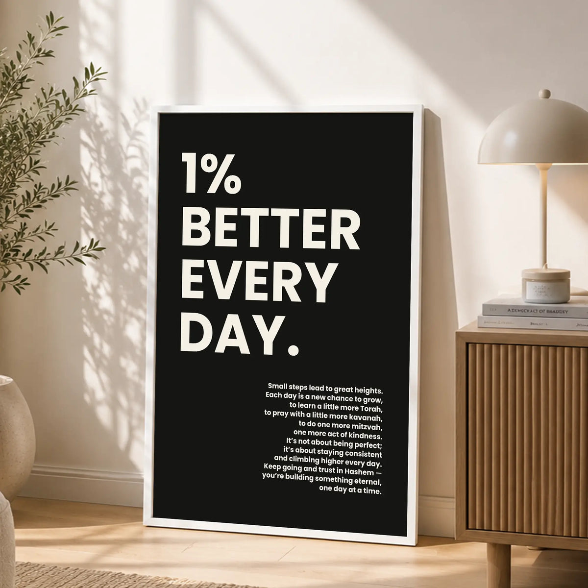 1% Better Every Day inspirational Jewish poster in white frame on sideboard